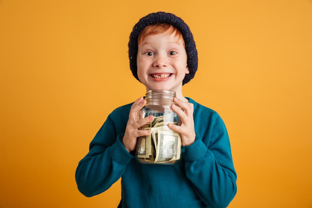 Kid with savings jar