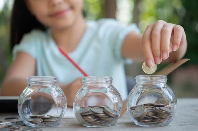 Child saving money in jar